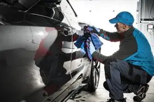 Professional Automotive Worker Cleaning Car Body Using Soft Cloth berkshire mobile valeting